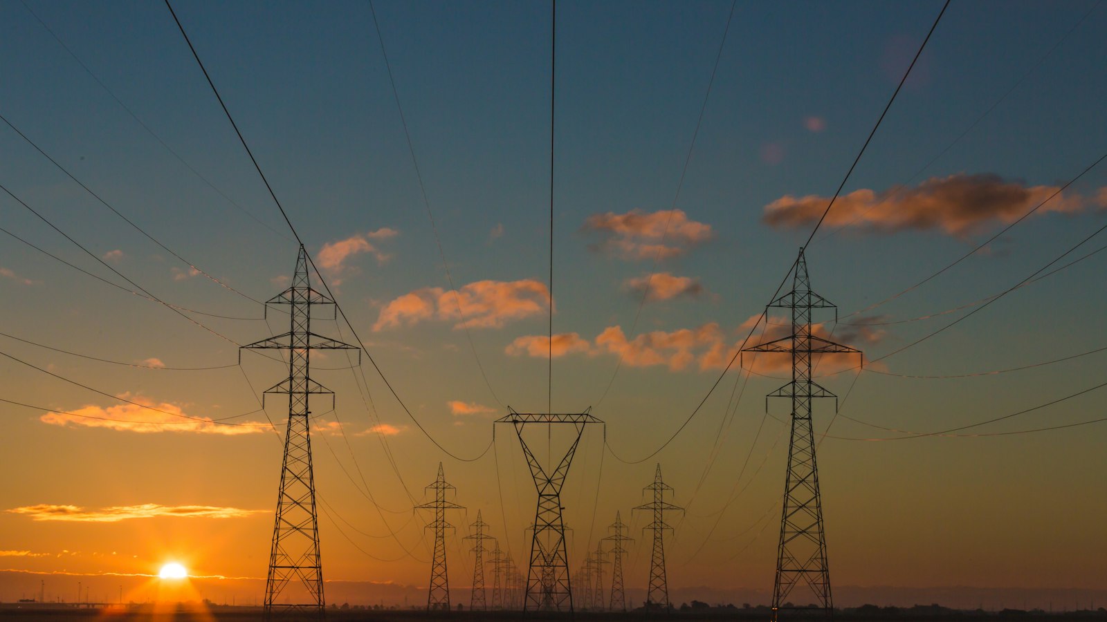 Electricity transmission towers at sunset