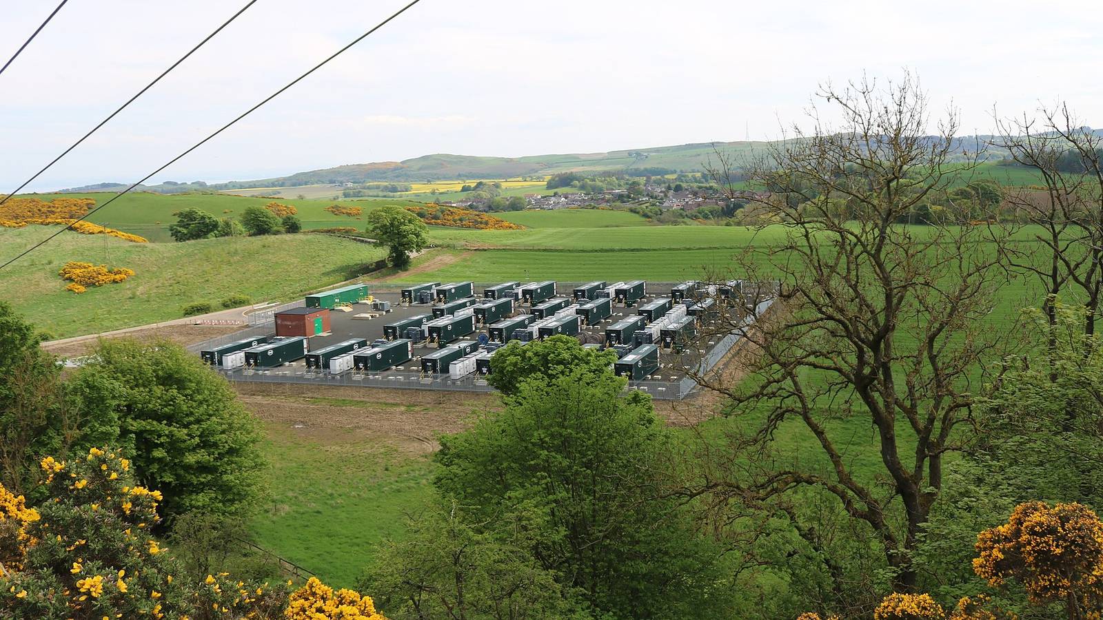 Aerial view of a utility-scale battery storage farm undergoing BESS repowering and capacity augmentation