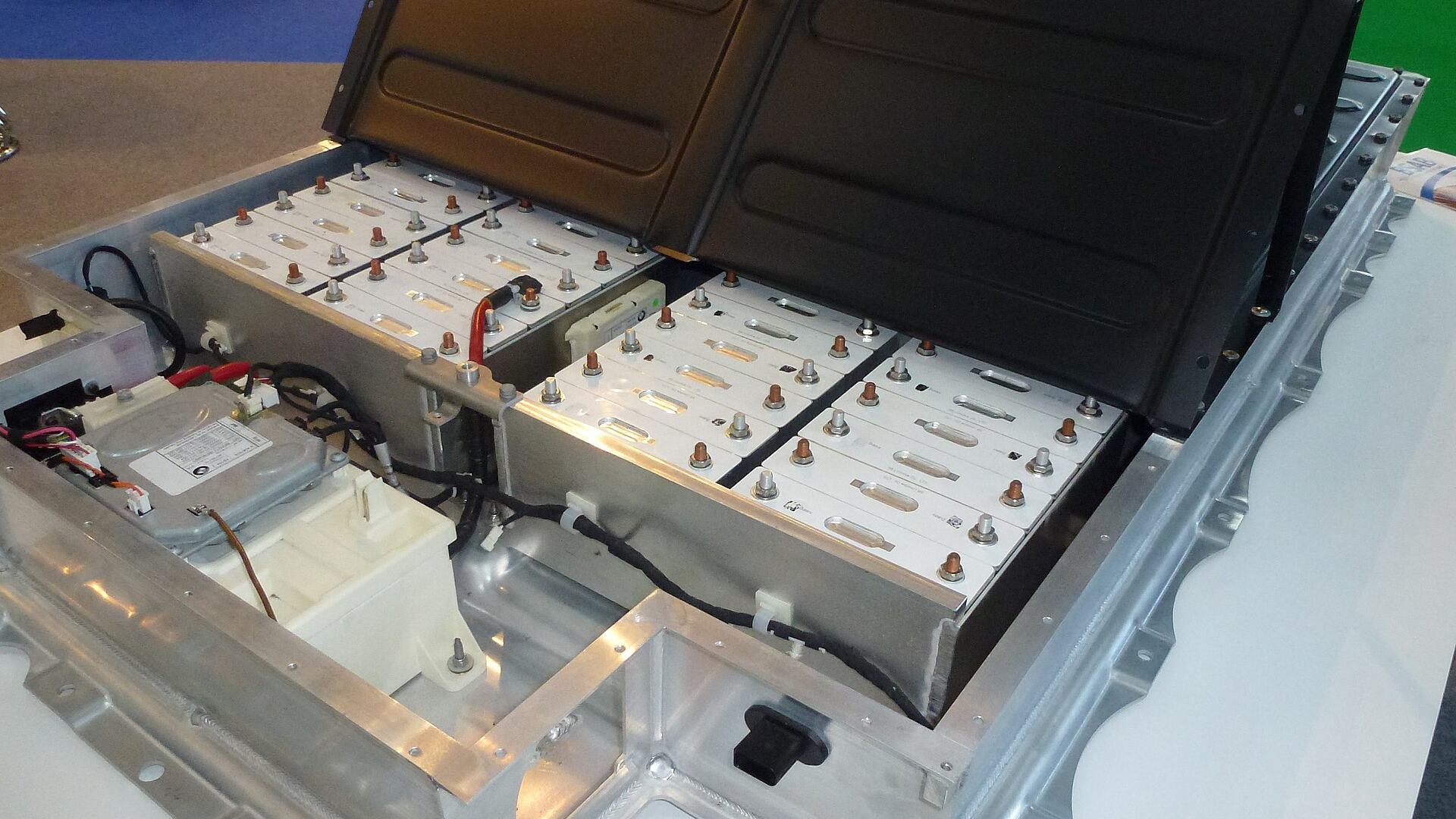 Second-life battery storage: an opened electric-vehicle battery pack showing prismatic lithium cells and modules reused for stationary energy storage