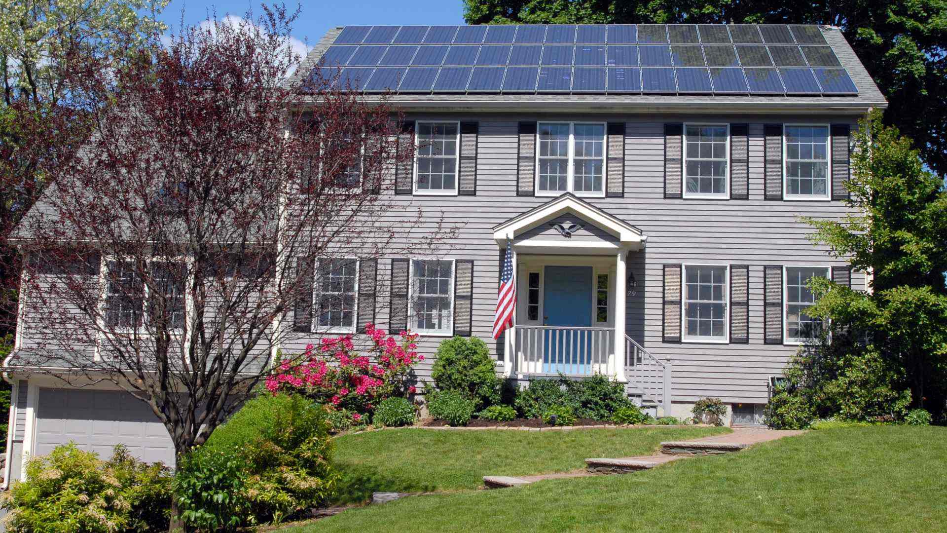 Rooftop solar panels on a suburban family home - the typical site for a home battery payback calculation in 2026